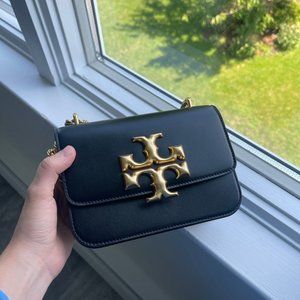 Small convertible shoulder bag made by Tory Burch.